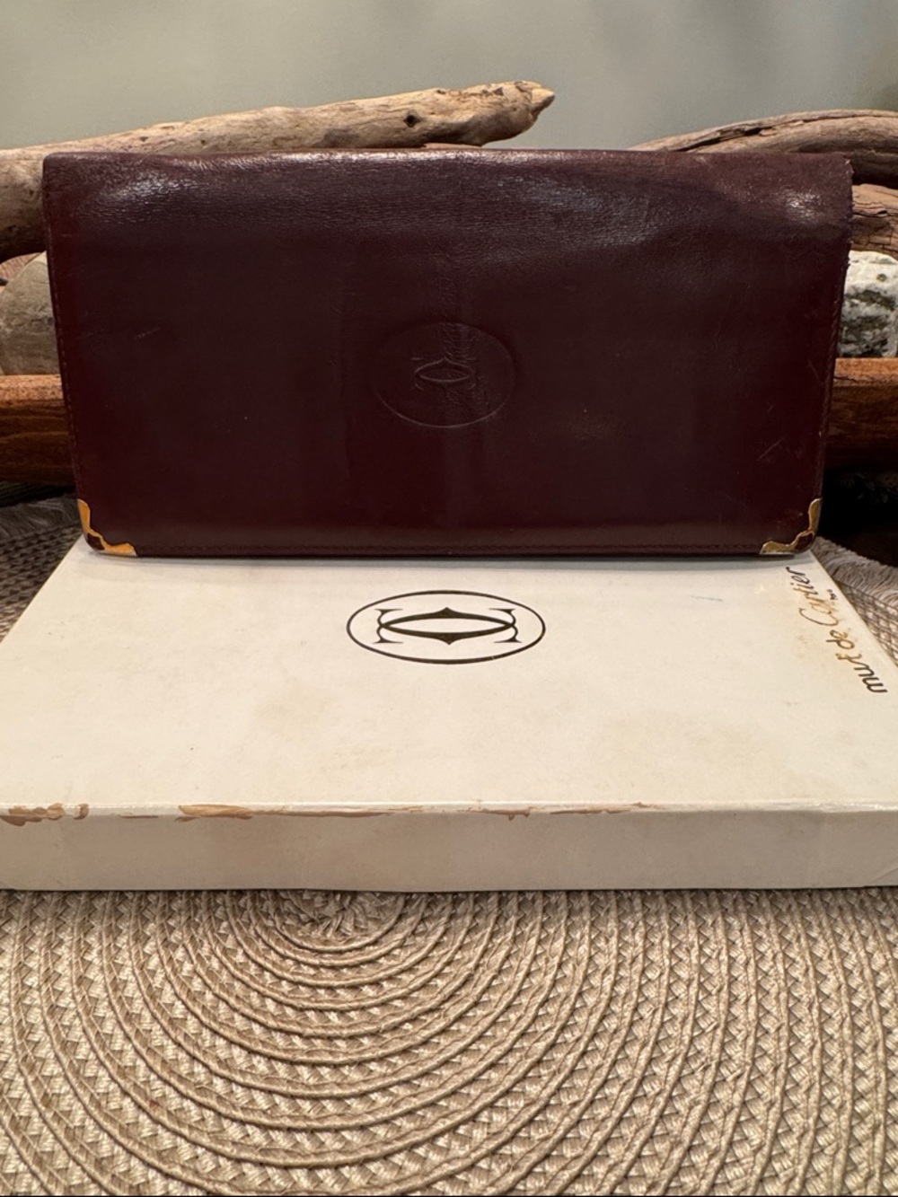 Cartier burgundy leather wallet with gold corner accents